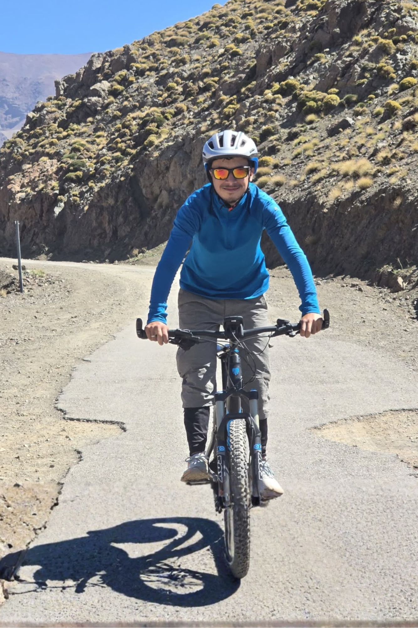 High Atlas mountain guide cycling near Imlil during a day tour